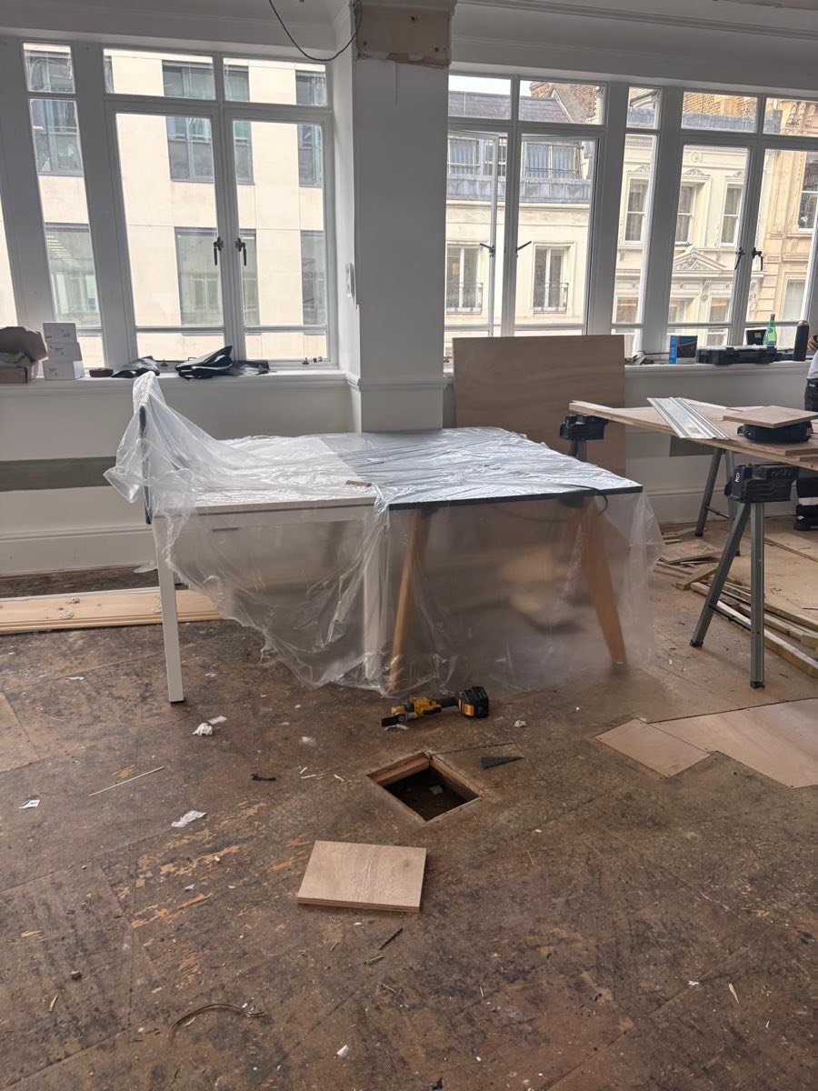 Before: Office floor stripped back to the slab