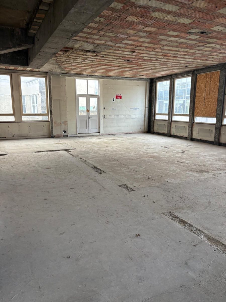 Office stripped back to exposed ceiling slab and screed